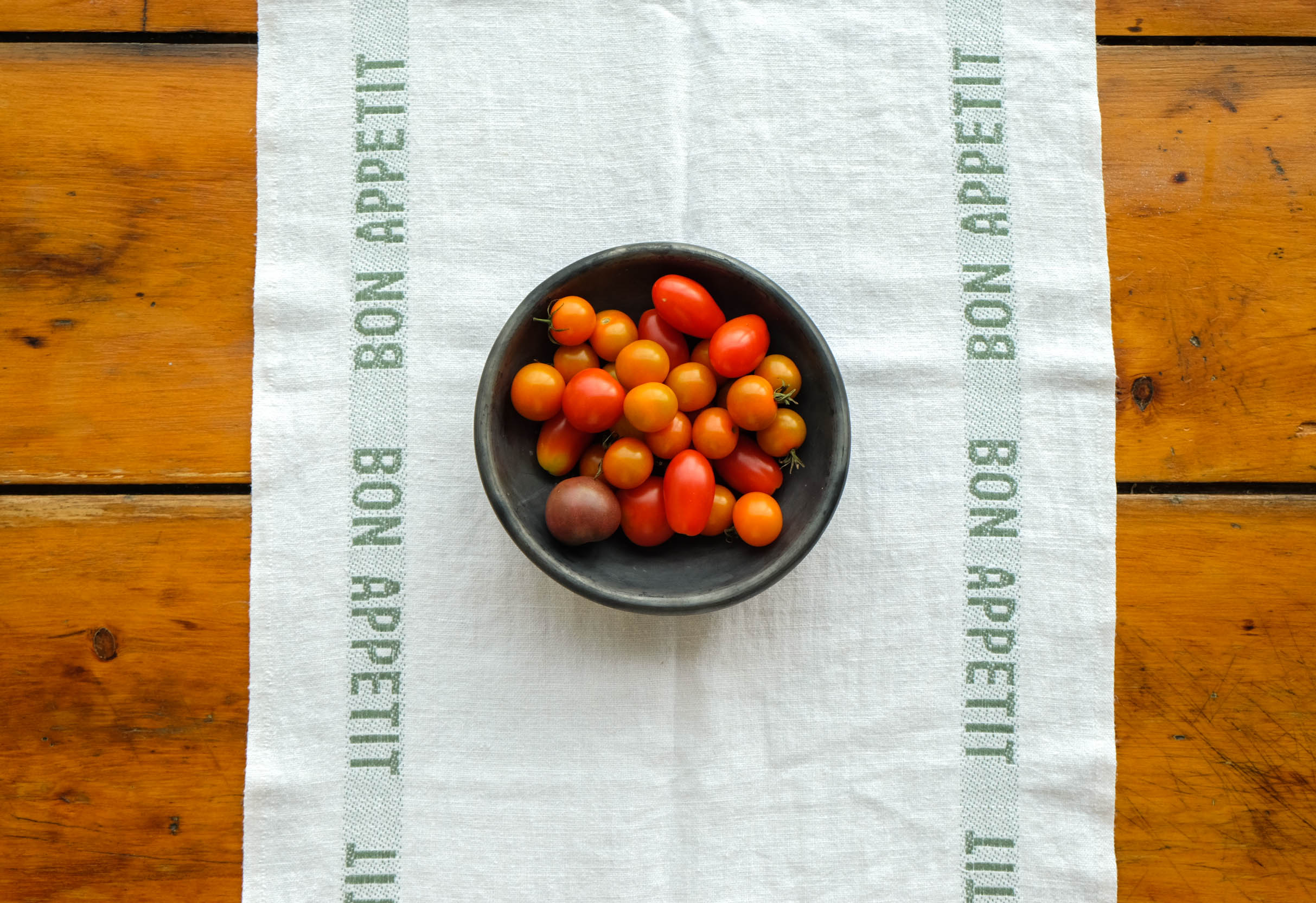 Bon Appetit table runner with a bowl of tomatoes
