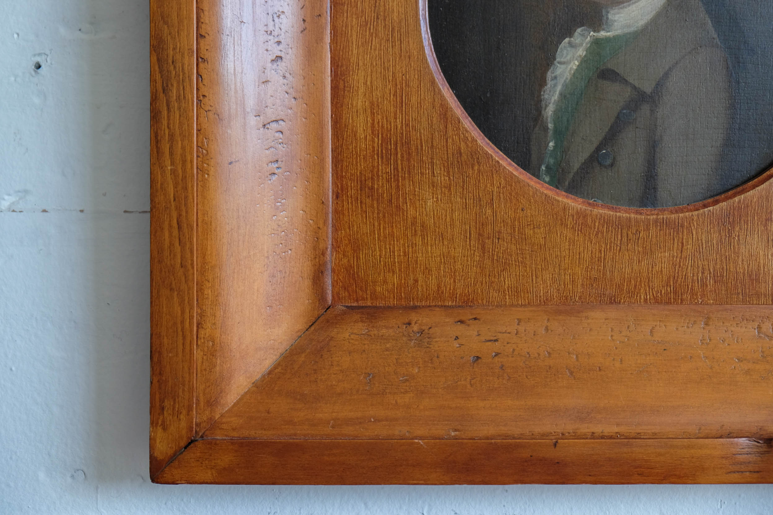 Closeup of an antique profile painting with a wooden frame