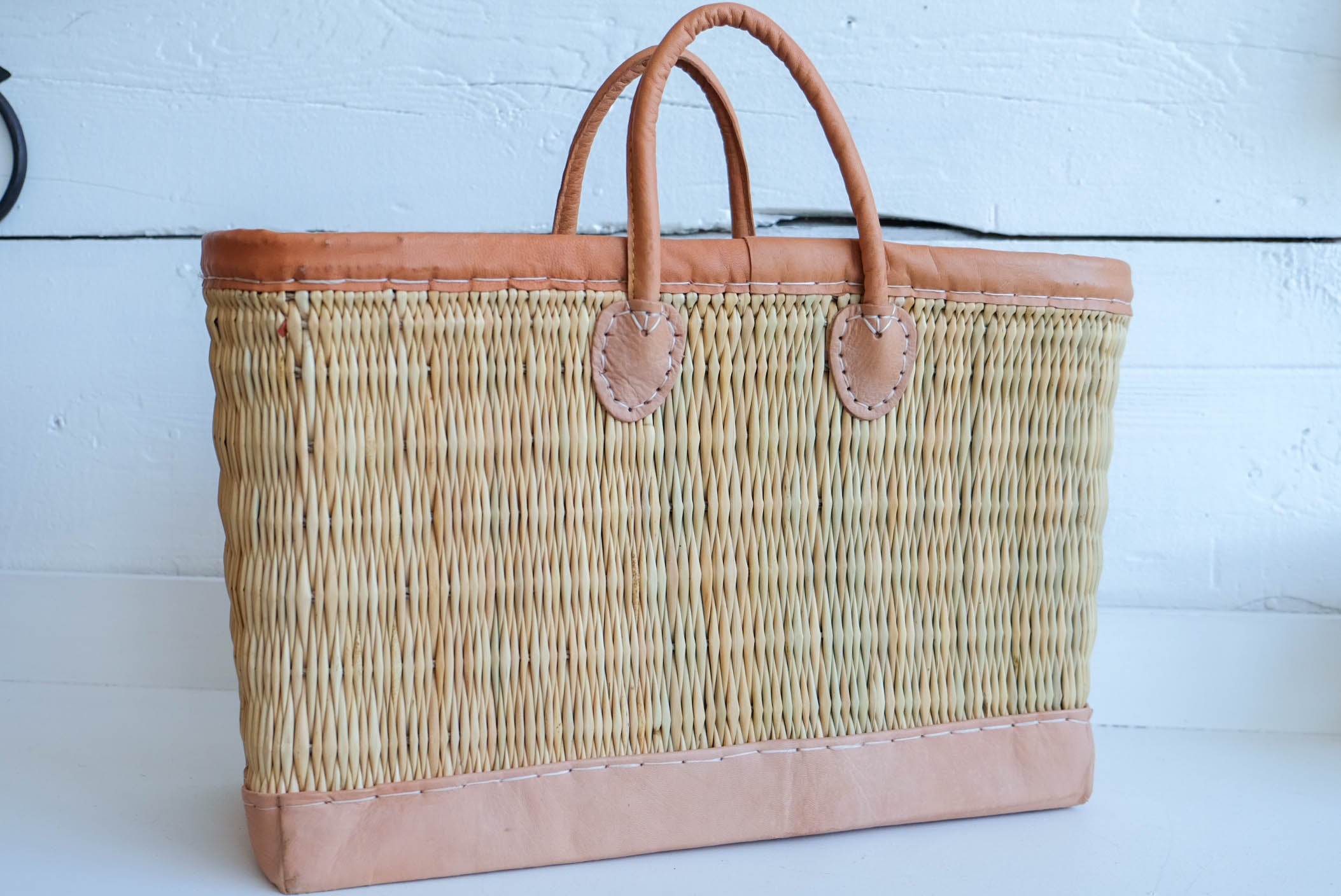 Leather trimmed tote made with water reed