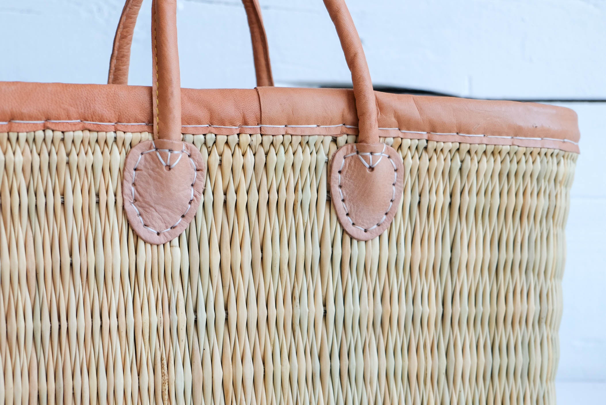 Leather trimmed tote made with water reed closeup