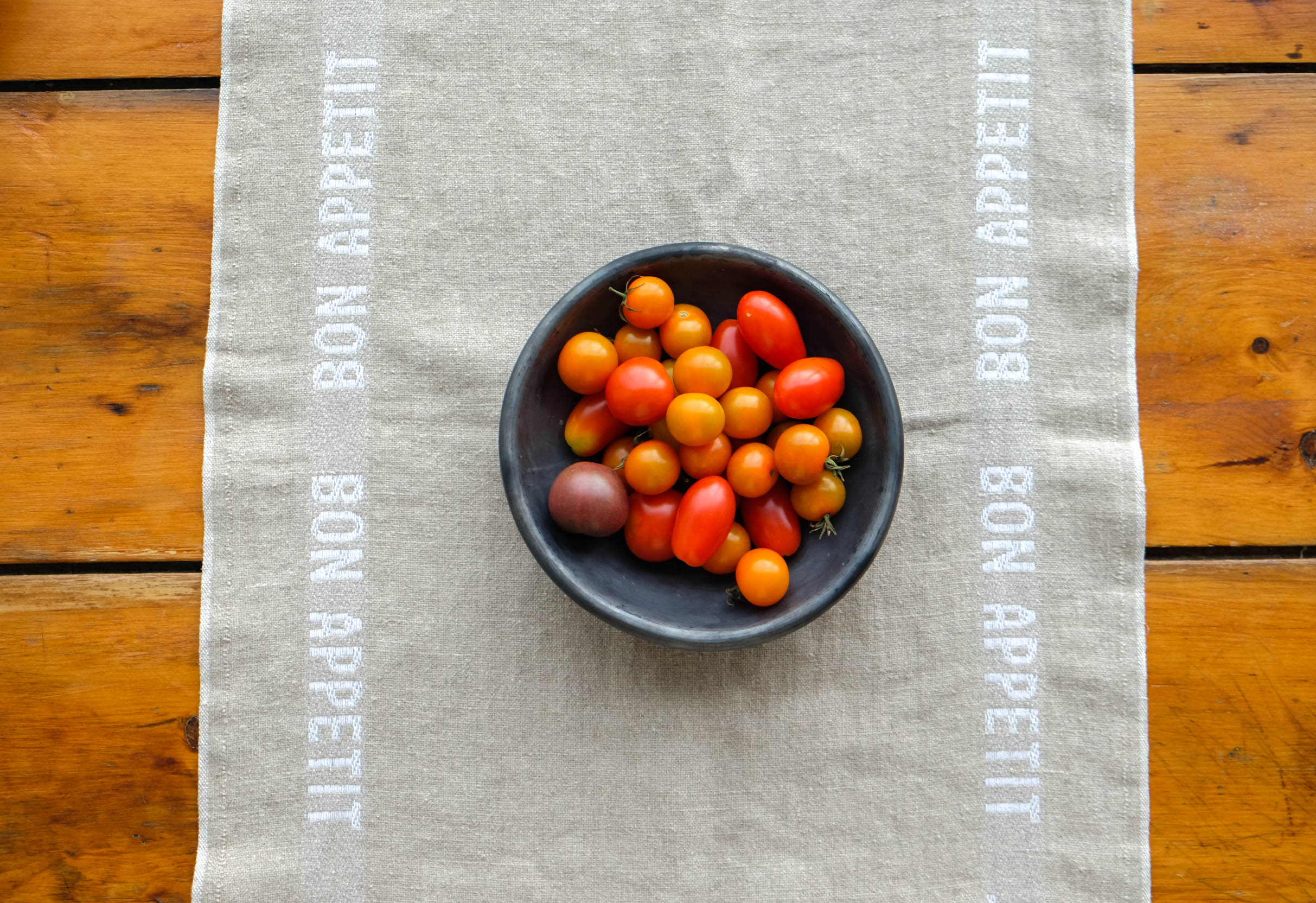 Bon Appetit table runner with a bowl of tomatoes